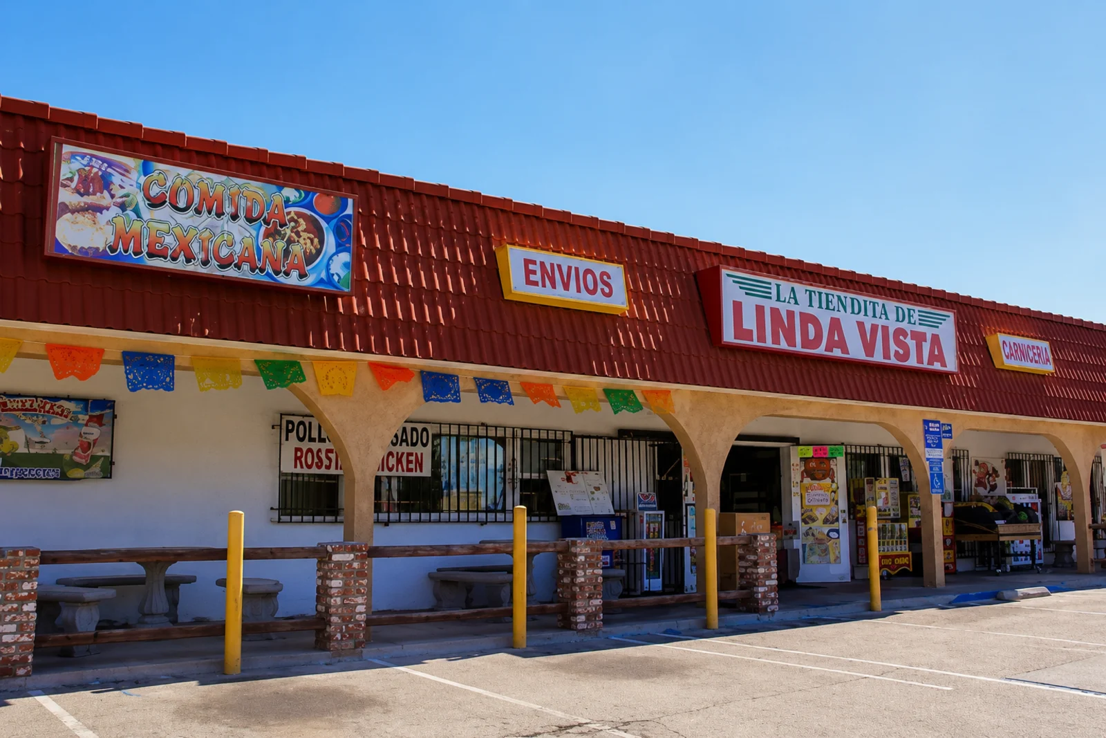 La Tiendita de Linda Vista storefront with papel picado banners, Envíos and Comida Mexicana signs on Ulric St